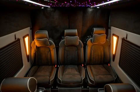 Comfortable interior of a passenger bus with soft seats Stock Photos