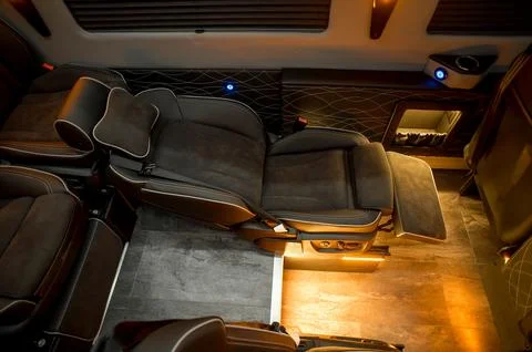 Comfortable interior of a passenger bus with soft seats Stock-Fotos