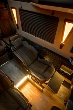 Comfortable interior of a passenger bus with soft seats Stock Photos
