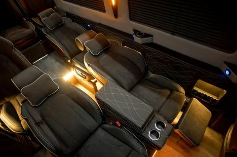 Comfortable interior of a passenger bus with soft seats Stock Photos