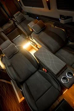 Comfortable interior of a passenger bus with soft seats Stock Photos