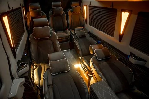 Comfortable interior of a passenger bus with soft seats Stock Photos