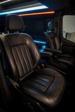 Comfortable interior of a passenger bus with soft seats Stock Photos