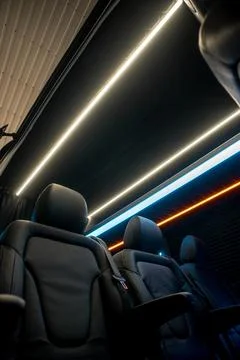 Comfortable interior of a passenger bus with soft seats Stock Photos