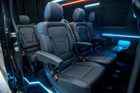 Comfortable interior of a passenger bus with soft seats Stock Photos