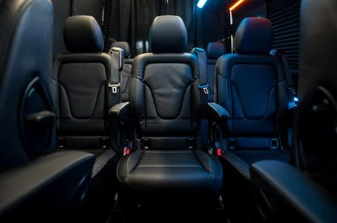 Comfortable interior of a passenger bus with soft seats Stock Photos