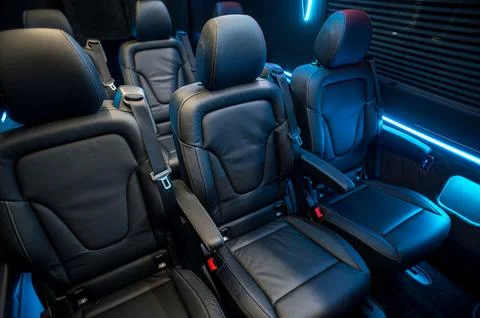 Comfortable interior of a passenger bus with soft seats Stock Photos