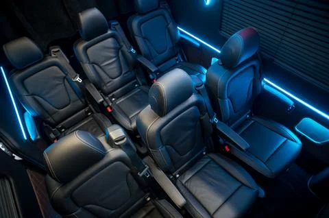 Comfortable interior of a passenger bus with soft seats Stock Photos