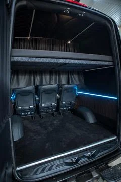 Comfortable interior of a passenger bus with soft seats Stock Photos