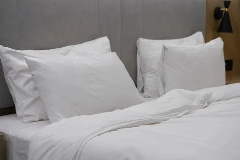 A comfortable king size bed with crisp white bedding in a modern hotel room, Stock Photos