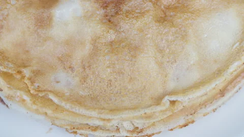 Comfortable morning presentation featuring textured pancakes and layered crepes. Stock Footage 332816338
