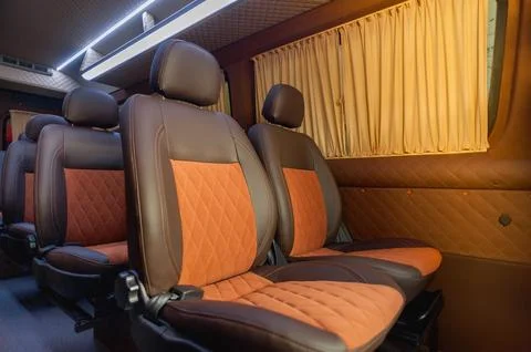Comfortable passenger bus interior with upholstered seats Stock Photos