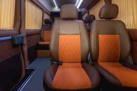 Comfortable passenger bus interior with upholstered seats Stock Photos