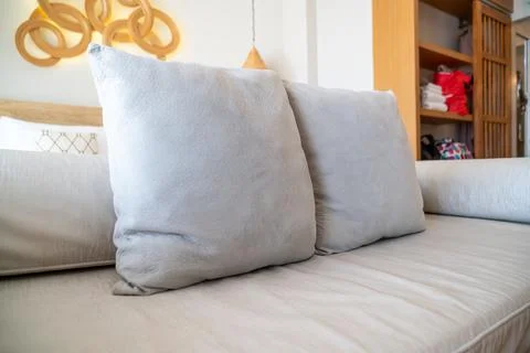 Comfortable pillows on end of bed sofa Stock Photos