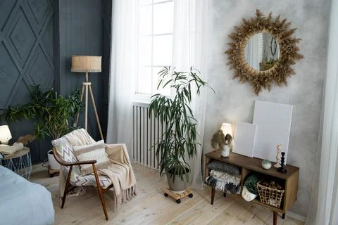 Comfortable seating area with a patterned armchair, cozy blanket, and fringed Stock Photos