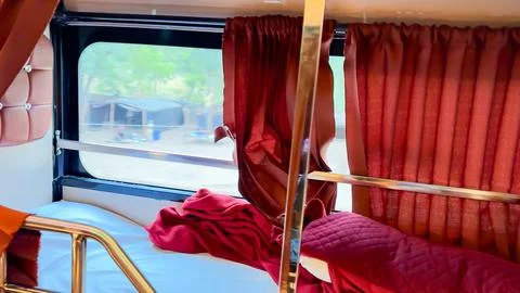 Comfortable Sleeper Bus Cabin With Bed Berth Pillow and Curtains Stock Photos