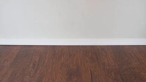 Comfortable Slippers fall on the floor one by one on the wooden floor Stock Footage 98379511