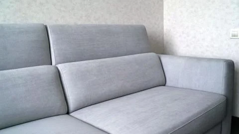 Comfortable sofa in the apartment. Part of the sofa in the frame. Ivory sofa Stock Photos