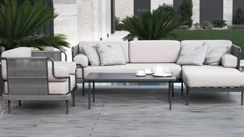 Comfortable sofa area in the courtyard of a luxury country villa with palm trees Stock Footage 220773023