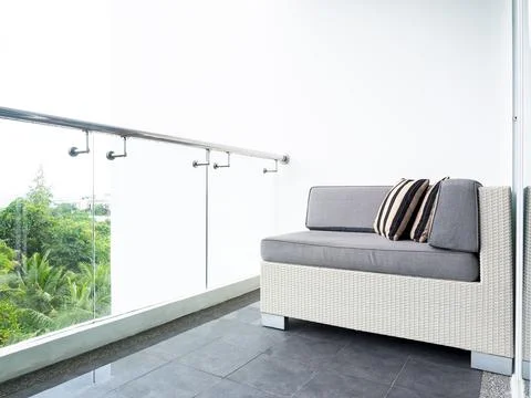 Comfortable sofa bed with pillows decorated on balcony and patio. Stock Photos
