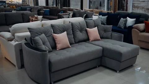 Comfortable sofa with gray and red cushions arranged in a furniture store. 4k 库存影片 232056631