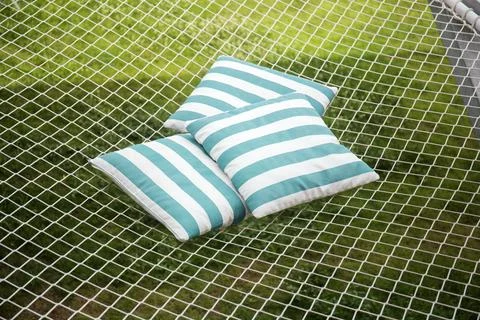 Comfortable top view pillows are placed on a rope net for rest and relaxation Stock Photos