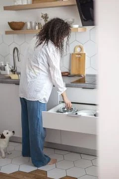 Comfortable white gray kitchen interior open box full of various crockery Stock Photos