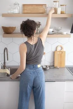 Comfortable white gray kitchen interior open box full of various crockery Stock Photos