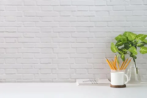 Comfortable workplace with blank picture frame, coffee cup, book and statione Stock-Fotos