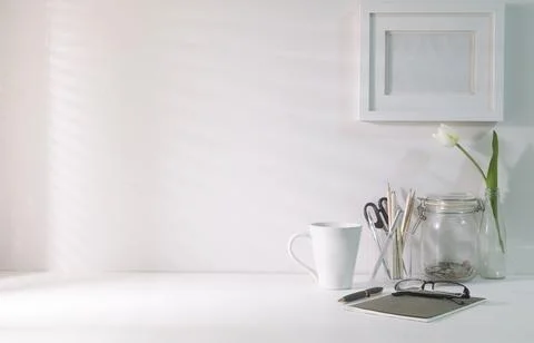 Comfortable workplace. Blank picture frame, coffee cup, notebook and statio.. Foto stock