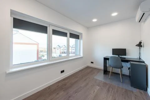 Comfortable workplace with computer near white wall in stylish minimalism r.. Stock Photos