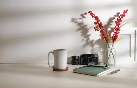 Comfortable workplace with cup of coffee, camera, notebooks and picture fra.. Foto stock