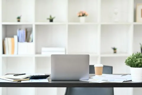 Comfortable workplace with laptop, documents and office supplies on black wooden Stock Photos