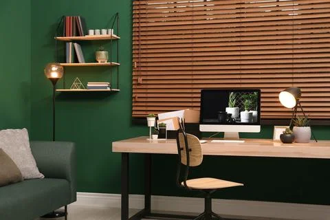 Comfortable workplace with modern computer near window in room. Interior desi Stock Photos
