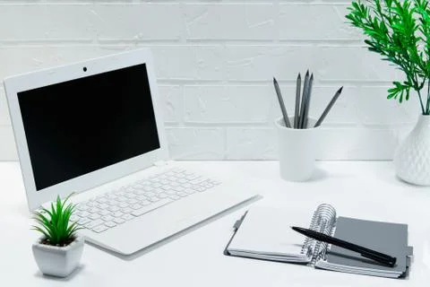 Comfortable workplace office - work table with blank white laptop and noteboo Stock Photos