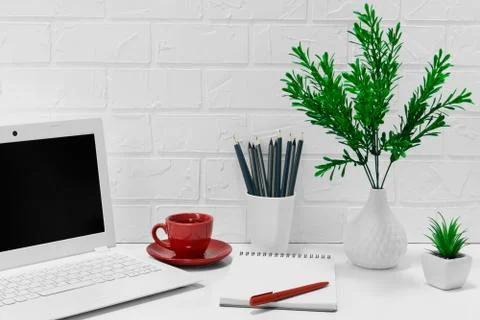 Comfortable workplace office - work table with blank white laptop and noteboo Stock Photos