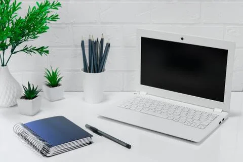 Comfortable workplace office - work table with blank white laptop and noteboo Stock Photos