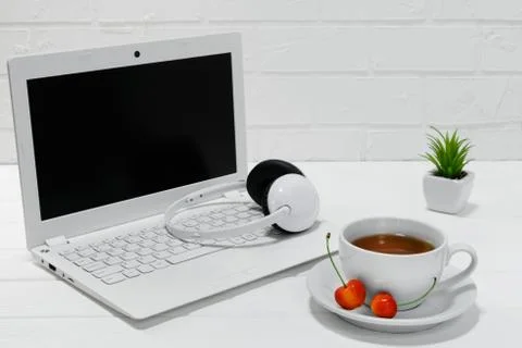 Comfortable workplace office - work table with blank white laptop headphones Stock Photos