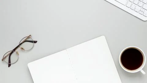 Comfortable workspace featuring coffee, keyboard, glasses and notebook for a  Stock Photos
