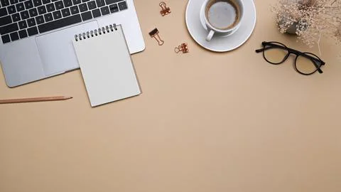 Comfortable workspace with laptop computer, notepad, glasses and coffee cup on Stock Photos