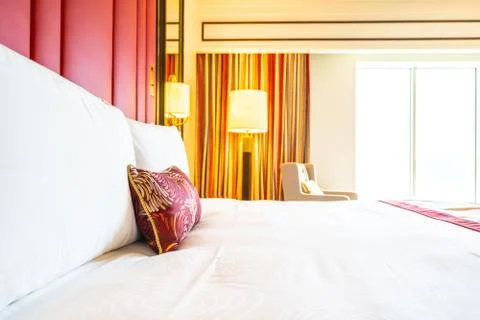 Comfotable pillow on bed with light lamp decoration Stock Photos