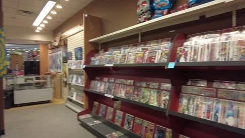 Comic Book Store Right To Left Pan Of Display Stock Footage 246321073
