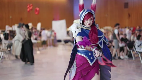 Comic con cosplayer Xayah character pose in slow mov 4K Stock Footage 195239230