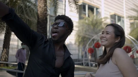 Comic couple have fun taking selfie outdoors. Leisure time and romantic Stock Footage 217410175