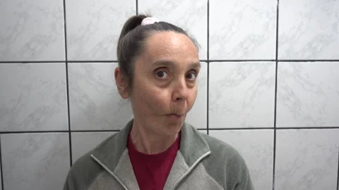 Comic face expressions of middle-aged woman looking in the mirrow Stock Footage 333247650