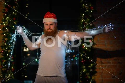 A comic image of santa claus in underwear on christmas eve. A man