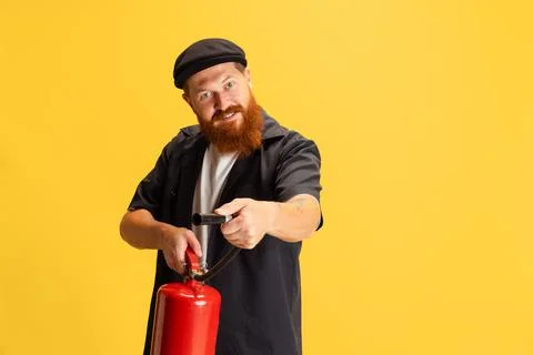 Comic portrait of stylish red-bearded man, barber in black cap having fun Stock Photos