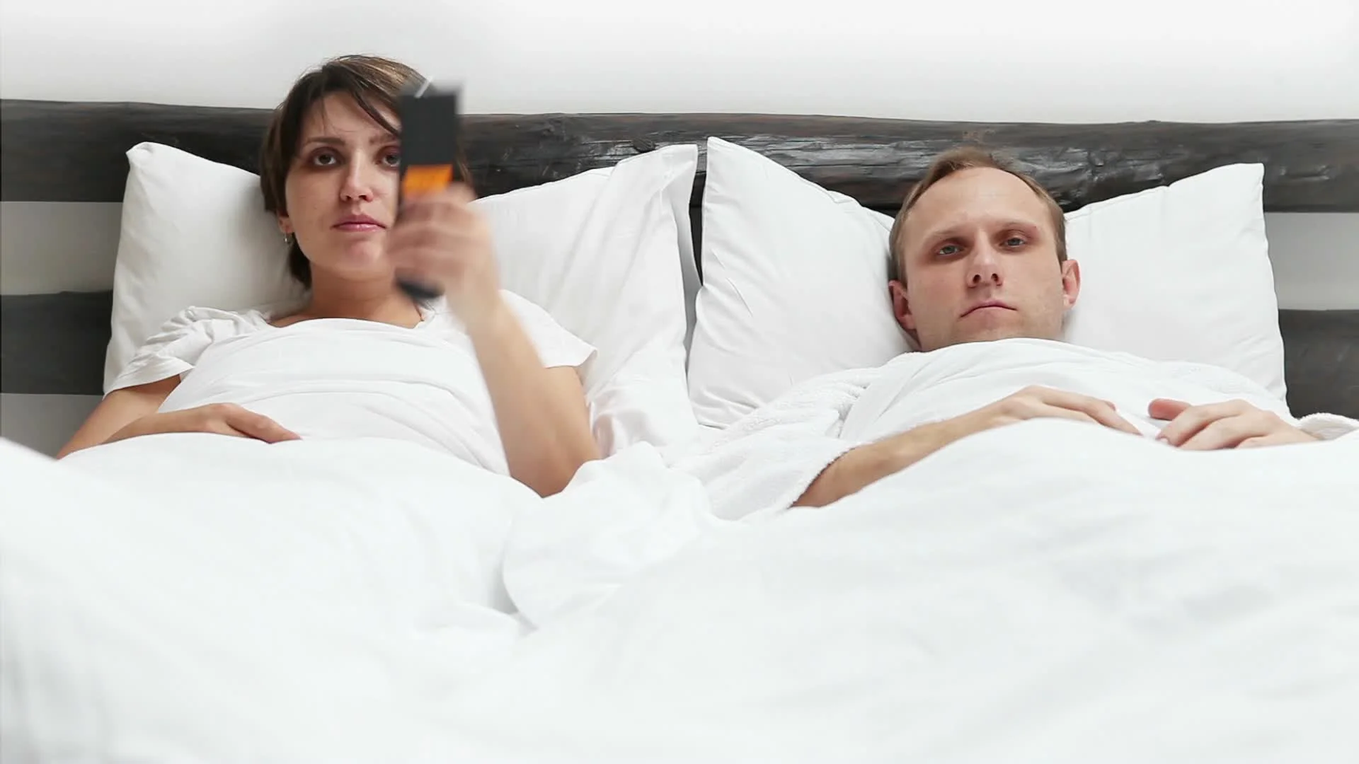 Comic scene - Wife and Husband TV Remote control conflict in Bed