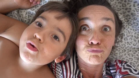 Comic selfie makers mother and son monkey on camera lolling and biting Stock Footage 115409198
