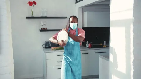 Comical black man wearing face mask moving his body in funny dance in the Stock Footage 131668988